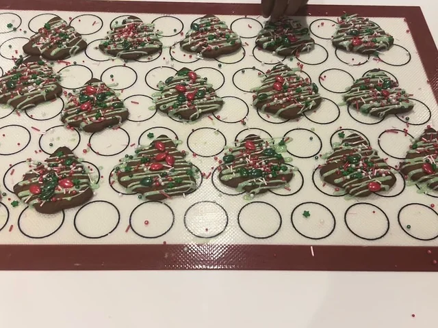 A tray of hand-decorated cookies in production